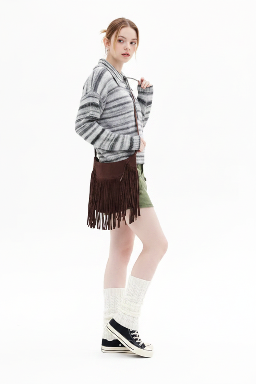 Person wearing a striped sweater, green shorts, and white socks with black shoes on a white background