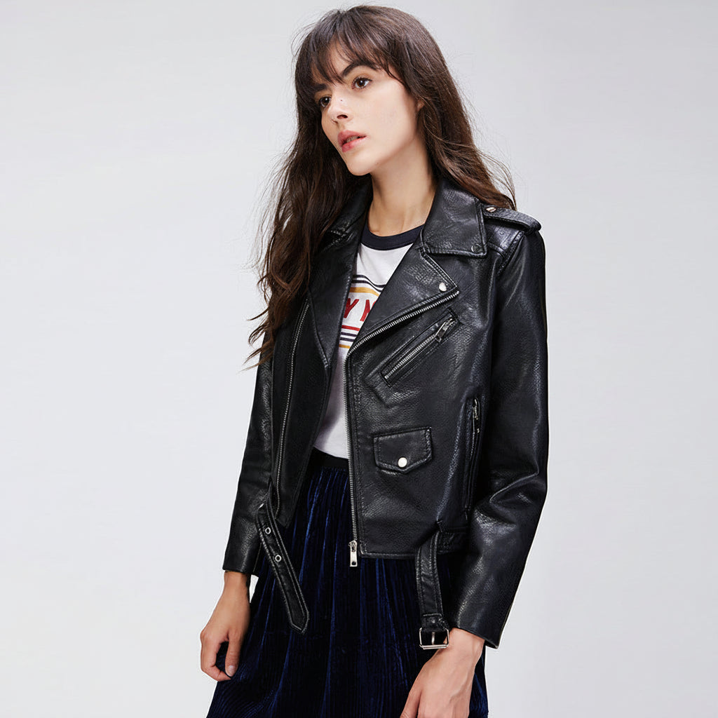 Woman wearing a black leather jacket on a gray background