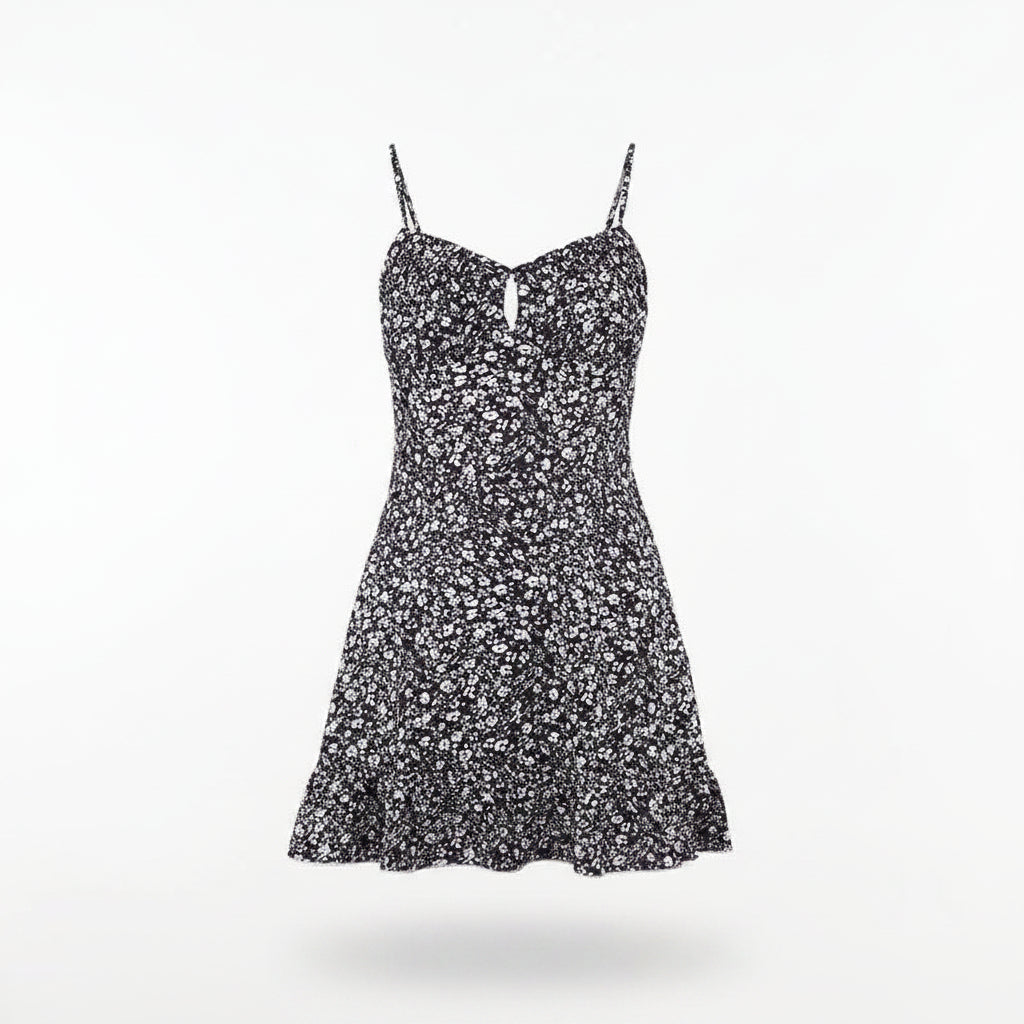 Black floral dress on a hanger against a white background